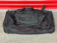 Large rolling duffel opened with weekender bag nested inside
