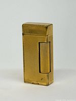 Front angled view of gold plated Dunhill lighter, cap closed