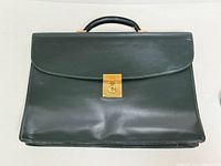 Front view of attaché showing leather exterior, lock and overall condition
