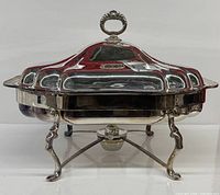 Complete chafing dish assembled with lid, stand and burner visible