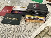 All DVDs stacked; shows titles on spines of right stack and slipcases on left