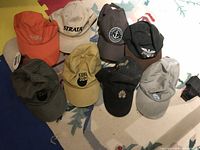 all eight caps laid out to show colors, logos, and overall condition