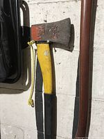 Full view of axe showing head, handle, grip and lanyard