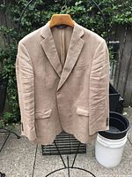 Front view of tan linen Brooks Brothers blazer hanging