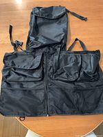 Both storage bags laid flat showing pockets, zippers and mesh