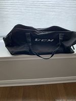 Front view of black CCM duffle bag with logo and handles