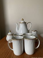 full set showing coffee pot, creamer, sugar bowl and four mugs