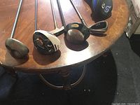 Four club heads on table