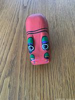 Front view of red hand painted wooden hippopotamus figurine