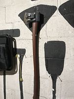 Full view of axe hanging on wall