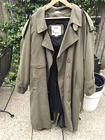 Front view of olive green London Fog raincoat on hanger