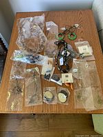 Overview of all jewelry pieces on table in plastic bags
