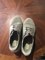 Top view showing both Skechers slip-on sneakers and insole branding