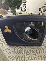 Front of blue carrying case with Mr. Clean graphic