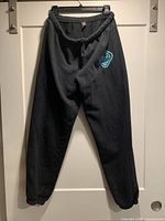 Front view of black sweatpants on hanger