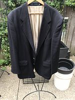 Front view of navy blazer on hanger