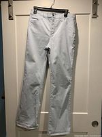 Front view of light blue NYDJ jeans hanging