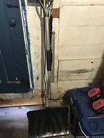 Full view of snow shovel front showing scoop and handle
