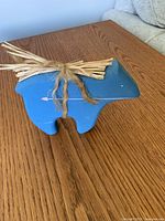 Front view of blue wooden animal figurine on table