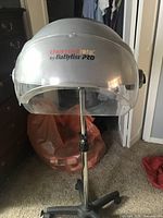 Front view of BaBylissPRO Thermal Ionic hood dryer showing logo and clear visor