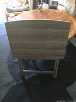 TV tray table folded standing upright