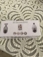 Front of box showing WiFi Panoramic Camera bulb and app images