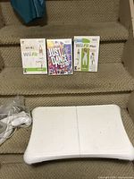Wii Fit, Just Dance 2016, Wii Fit Plus game cases and balance board visible