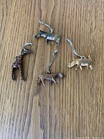 Overview all four wooden animal ornaments with twine hangers