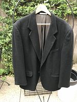 Front view of black wool-cashmere jacket on hanger