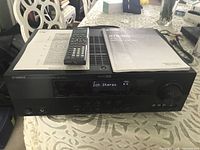 Receiver top view with remote, manual and reference sheet