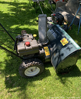 Left side view showing engine, auger housing, tires, Mastercraft branding