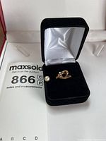 Ring in box with loose pearl showing overall design