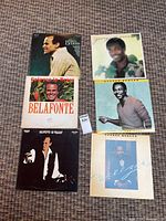 All six record albums laid out, covers visible