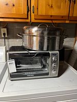 Black+Decker countertop oven with stainless steel roasting pan on top