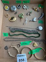 Overview of all costume jewelry pieces arranged in cardboard tray