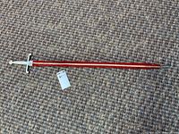 Full view of sword in sheath on carpet background