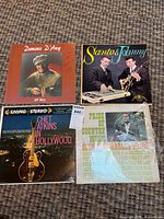 All four record covers arranged together