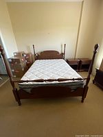 Full view of assembled four-poster bed with mattress and box spring