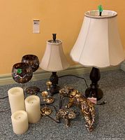 Group shot of lamps, pillar candles, mosaic holders, gold taper holders, tiger and elephant figurines