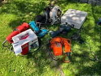 Group shot showing all power tools and boxed Jobmate sander on grass