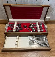 Open canteen showing upper tray with forks and spoons, lower tray partly pulled with knives