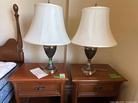 Both table lamps with shades on nightstands