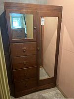 Front view showing mirrored door and four drawer stack