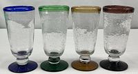 Front view of all four colored pedestal bubble glasses