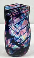 Front view of multicolored art glass vase
