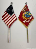 Front view of both metal flag banners showing painted details