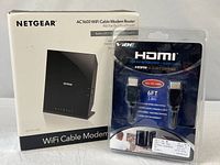 Netgear modem router box next to Vibe HDMI cable pack