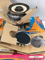 Stacked Polk EX speaker boxes with speakers partially removed showing packaging