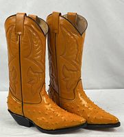 Full view of both honey colored western boots standing upright