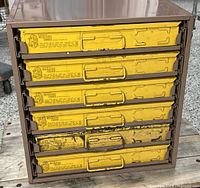 Front view of cabinet showing six yellow drawers in brown metal frame